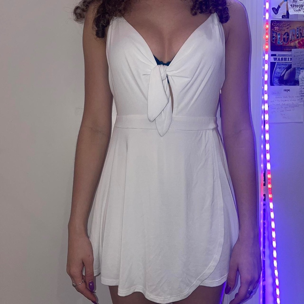 UO mini dress/romper w/ bow tie.Small zipper at side. Straps are adjustable.